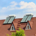 Solar water heaters on a residential house rooftop. Renewable en