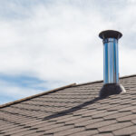 Chimney pipe from stainless steel on the roof of the house